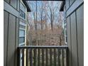 Private balcony offering a tranquil view of the surrounding wooded area at 5147 Roswell Rd # 9, Atlanta, GA 30342