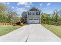 Charming two-story home featuring a front porch, two car garage and a fenced in yard at 85 Lawson St, Buford, GA 30518