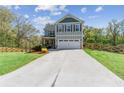 Charming two-story home featuring a front porch, two car garage and a fenced in yard at 85 Lawson St, Buford, GA 30518