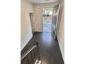 Inviting foyer with hardwood floors and natural light streaming through the open front door at 2102 Talmai Dr, Snellville, GA 30078