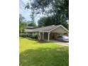 Charming home featuring a covered carport, complementing the lush green lawn at 4184 Red Laurel Way, Snellville, GA 30039