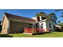 Exterior of home with brick and siding with raised garden area at 4662 Burns Rd, Lilburn, GA 30047