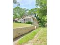 Side view of the house showing the yard and a concrete barrier at 502 S Evelyn Nw Pl, Atlanta, GA 30318