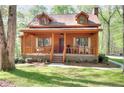 Charming cabin home featuring dormer windows and a welcoming front porch with seating at 2435 Farmer Road, Conyers, GA 30012