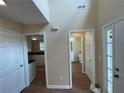 Hallway featuring wood floors and multiple doorways leading to various rooms within the home at 1421 Isleworth Cir, College Park, GA 30349