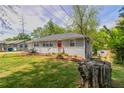 Charming single-story home with gray siding, brick foundation, red front door, and a lush, green lawn at 2032 Parker Ranch Se Rd, Atlanta, GA 30316