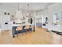 Bright kitchen featuring a large island with seating, stainless appliances, and hardwood floors at 1455 Rucker Cir, Woodstock, GA 30188