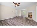 Inviting living room featuring a cozy stone fireplace and durable wood laminate flooring at 201 Rustin Dr, Dallas, GA 30157