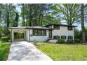 Beautiful home with a white painted brick exterior, carport and well-maintained lawn at 3031 San Jose Dr, Decatur, GA 30032