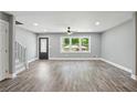 Newly renovated living room featuring hard surface floors, large windows, and modern ceiling fan at 3031 San Jose Dr, Decatur, GA 30032