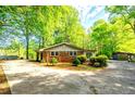 A charming brick home is surrounded by small, decorative shrubs at 1098 Cown Rd, Villa Rica, GA 30180