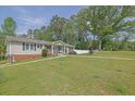 Lovely single story home on expansive yard with mature trees, manicured lawn, and welcoming curb appeal at 5185 Twin Oak Ne Dr, Woodstock, GA 30188