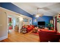 Cozy living room with hardwood floors, a blue accent wall, and ample natural light offers great ambiance at 2502 Kerry Ne Ct, Marietta, GA 30066