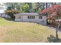 Picture-perfect home boasting a garage, lush lawn, and beautiful trees surrounding the property at 810 Parkway Se Dr, Smyrna, GA 30080