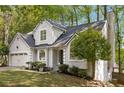 Charming home featuring a two-car garage, chimney and mature trees at 1200 Taylor Oaks Dr, Roswell, GA 30076