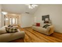 Open-concept living area with hardwood floors and views of the front entrance at 160 Vinnys Way, Covington, GA 30014