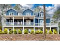 Beautiful two-story home featuring a covered front porch, blue siding and a landscaped yard at 4101 Brookview Se Dr, Atlanta, GA 30339