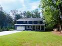 Charming two-story navy home with a manicured lawn, a paved driveway and an attached garage at 4101 Brookview Se Dr, Atlanta, GA 30339