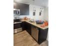 Modern kitchen featuring granite countertops, stainless steel appliances, and dark cabinets at 4829 Station Lane -Lot 30, Union City, GA 30349