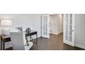 Bright home office with hardwood floors, French doors, and a stylish desk setup at 605 Vidalia Pkwy, Mcdonough, GA 30252