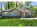 Charming home with attractive siding, a cozy front porch, and a beautifully landscaped front yard at 1186 Thomas Rd, Decatur, GA 30030