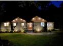 Charming home illuminated at night, featuring attractive exterior lighting, landscaping, and a welcoming entrance at 1186 Thomas Rd, Decatur, GA 30030