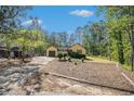 View of a ranch-style home featuring a well-manicured lawn and long driveway at 8083 Cypress Ct, Villa Rica, GA 30180