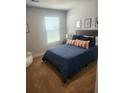 A cozy bedroom with a queen-sized bed, neutral walls, and a large window providing natural light at 4827 Station Lane -Lot 31, Union City, GA 30349