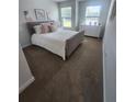 A light and airy bedroom with a plush bed, soft decor, and large windows overlooking the landscape at 4827 Station Lane -Lot 31, Union City, GA 30349