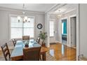 Elegant dining room featuring a modern chandelier, large windows, and hardwood floors at 1976 Boyd Trace Nw Ln, Atlanta, GA 30318