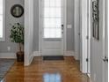 Inviting entryway with hardwood floors, light gray walls, and a bright white front door at 1976 Boyd Trace Nw Ln, Atlanta, GA 30318