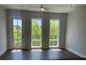 Bedroom with hardwood floors, light gray walls, and large windows with a treeline view at 1274 Longreen Terrace # 113, Atlanta, GA 30318