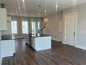 Open-concept kitchen featuring stainless steel appliances, a center island, and hardwood floors at 1274 Longreen Terrace # 113, Atlanta, GA 30318