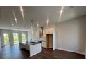 Living room with an open concept design into the kitchen and featuring hardwood floors throughout at 1274 Longreen Terrace # 113, Atlanta, GA 30318