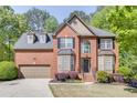 Charming brick home with meticulously landscaped front yard and classic architectural details at 1641 Rocky Knoll Ln, Dacula, GA 30019