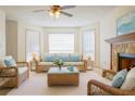 Bright living room with stone fireplace, ceiling fan, and lots of natural light at 1166 Memory Ln, Lawrenceville, GA 30044
