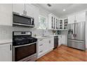 Modern kitchen featuring white cabinets, stainless steel appliances, and plenty of counter space at 1292 Eubanks Ave, Atlanta, GA 30344