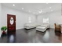 Open-concept living space with hardwood floors, a comfortable white sofa, and natural light at 1292 Eubanks Ave, Atlanta, GA 30344