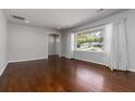 Bright living room featuring hardwood floors, large windows, and neutral paint at 2218 Edgemore Se Dr, Atlanta, GA 30316