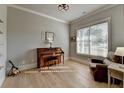 Cozy living room features hardwood floors, a window with natural light, piano, and a comfortable leather recliner at 86 Ewing Way, Dacula, GA 30019