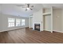 Living room featuring a fireplace, hardwood floors, and a ceiling fan at 2416 Centennial Hill Nw Way, Acworth, GA 30102