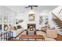 Bright living room featuring built-in bookcases, a cozy fireplace, and hardwood flooring at 1048 Standard Ne Dr, Brookhaven, GA 30319