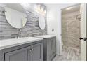 Elegant bathroom with double vanities and a tiled walk-in shower at 4440 Spring Mtn Ln, Powder Springs, GA 30127