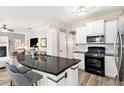 Modern kitchen features a black granite island and stainless steel appliances at 4440 Spring Mtn Ln, Powder Springs, GA 30127
