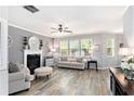 Comfortable living room with decorative fireplace and large windows at 4440 Spring Mtn Ln, Powder Springs, GA 30127