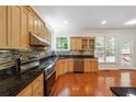 Modern kitchen with granite countertops and stainless steel appliances at 225 Bayswater Dr, Suwanee, GA 30024