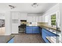 Modern kitchen featuring blue lower cabinets, stainless steel appliances, and ample counter space at 964 Crane Ne Rd, Atlanta, GA 30324