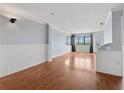Spacious living area with hardwood floors, crown molding, and large windows at 795 Hammond Dr # 2101, Atlanta, GA 30328