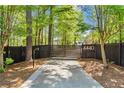 Gated driveway entrance featuring house number in a wooded setting at 4440 Webb Bridge Rd, Alpharetta, GA 30005