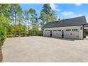 Spacious three-car garage with ample parking space and well-maintained landscaping at 4440 Webb Bridge Rd, Alpharetta, GA 30005